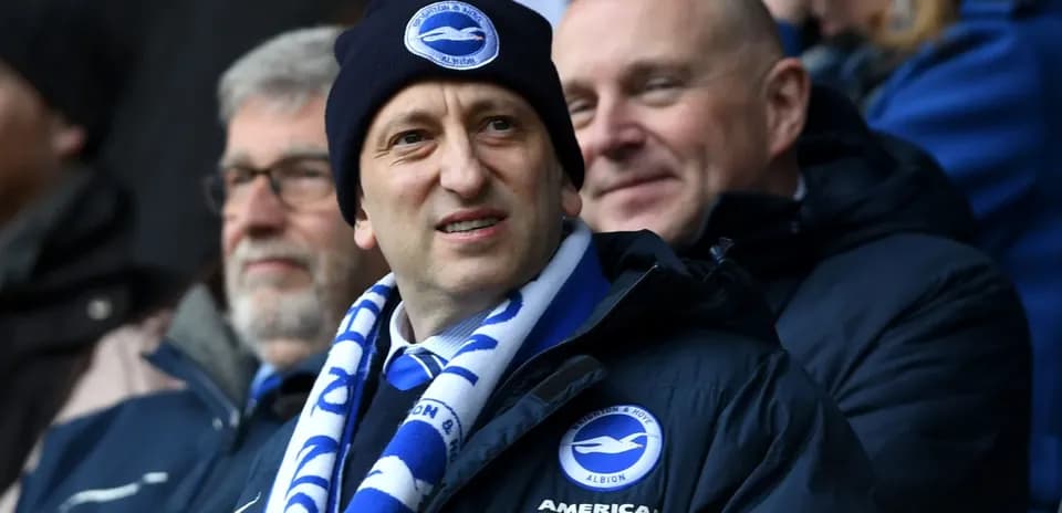Man wearing a Brighton scarf and beanie at match