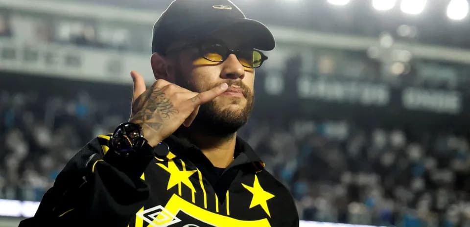 Person making a phone gesture in stadium