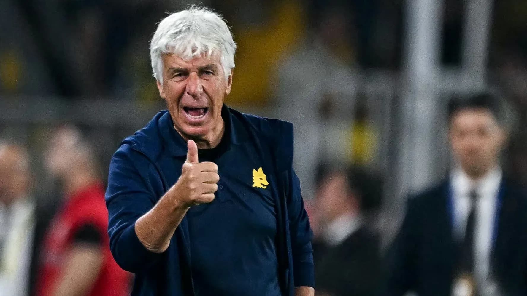 Coach giving thumbs up during match on sidelines