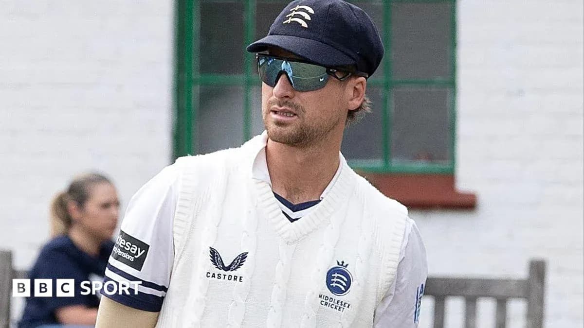 Cricketer wearing sunglasses and sweater on field