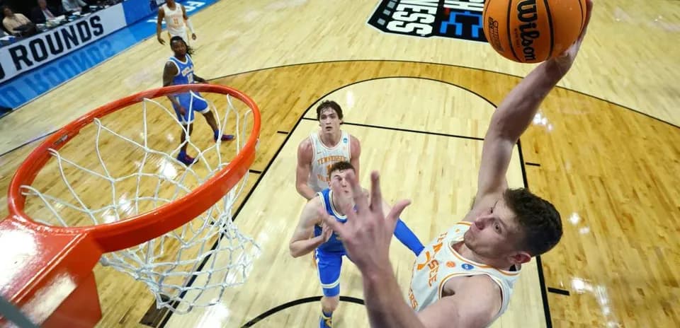 Player dunking during NCAA basketball tournament match