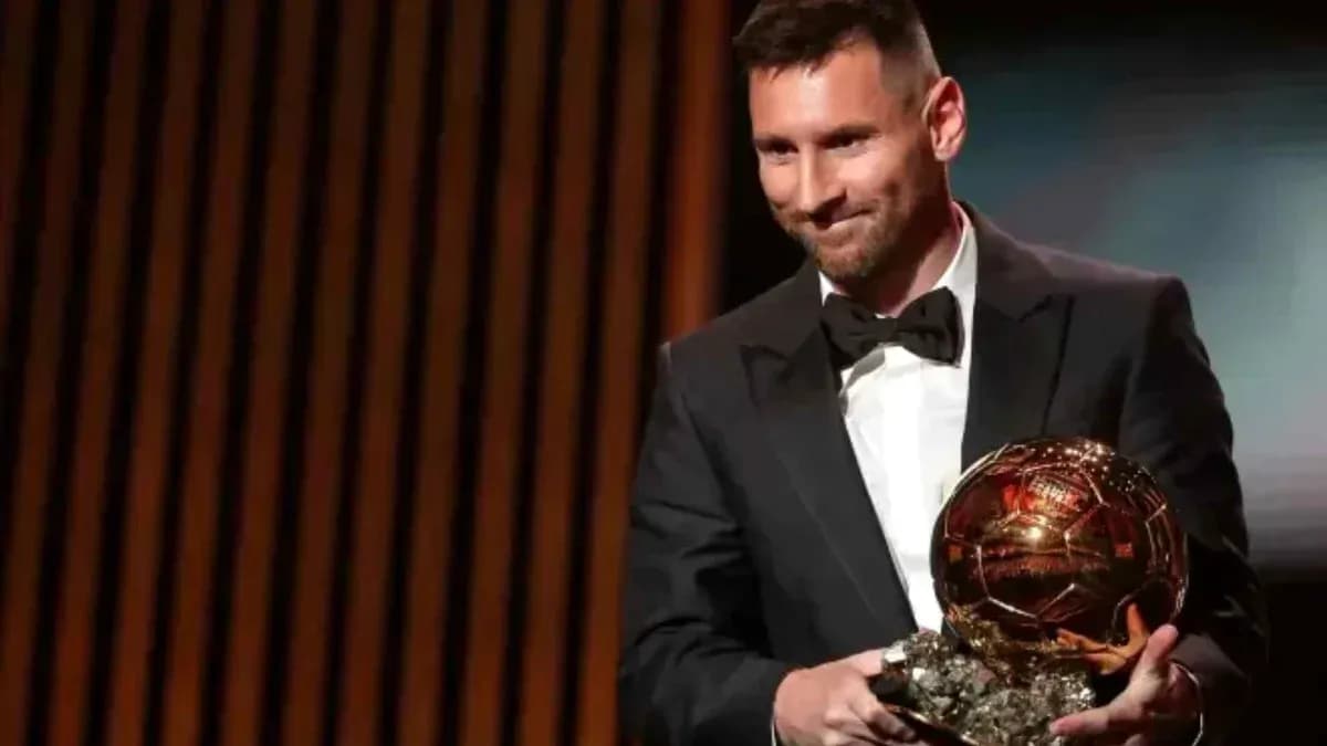 Player holding Ballon d'Or award on stage