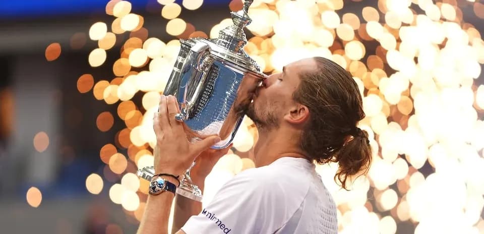 Player kissing trophy with fireworks in background