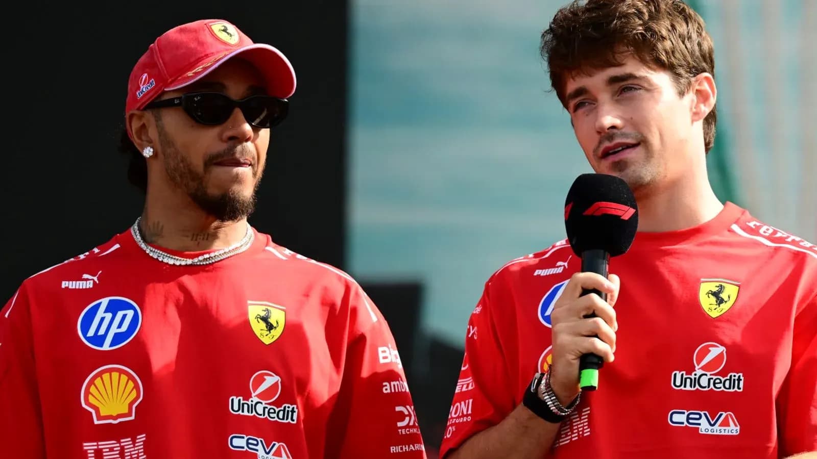 Two drivers in Ferrari shirts during press event