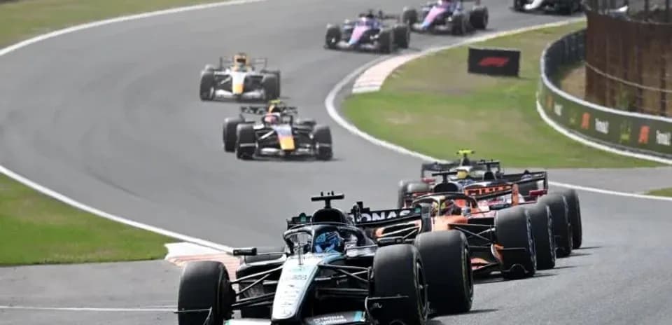 Formula 1 cars racing on a curved track