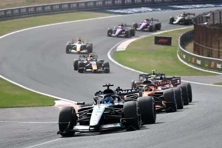 Formula 1 cars racing on a curved track