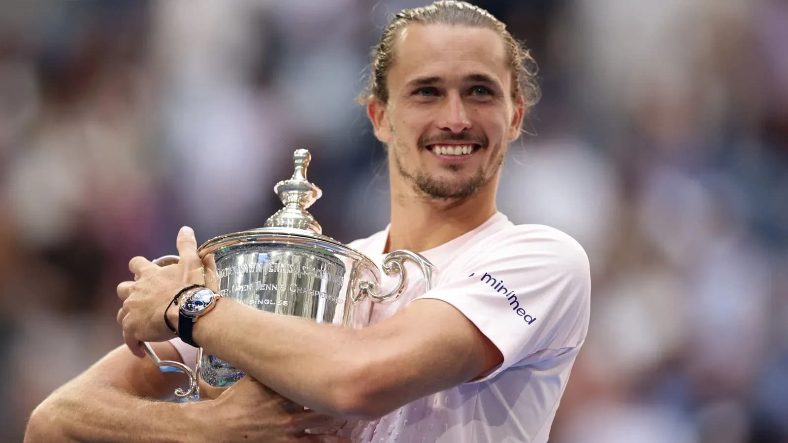 Player holding trophy after winning tennis championship
