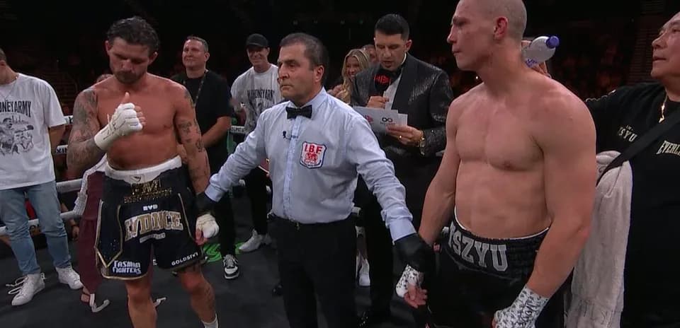 Boxers and referee at the match decision moment