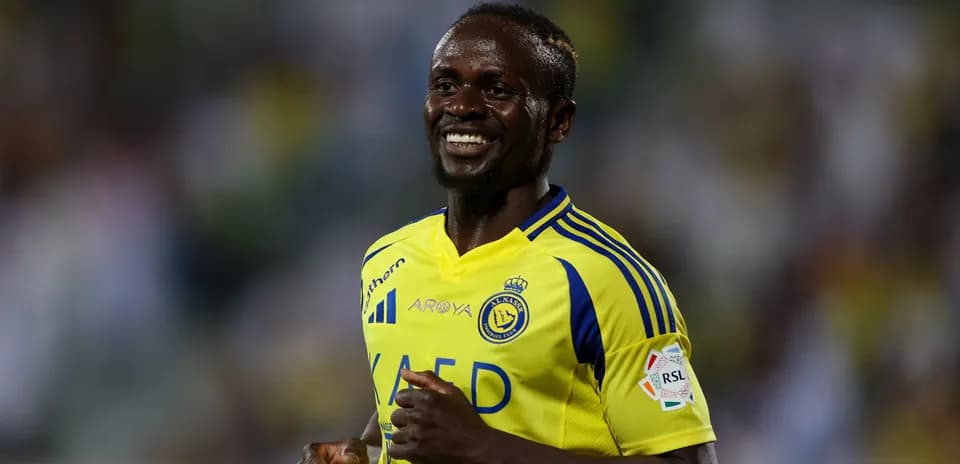 Player in yellow jersey smiling on the field