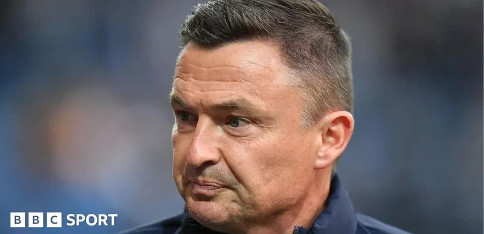 Coach focused during a match or press conference