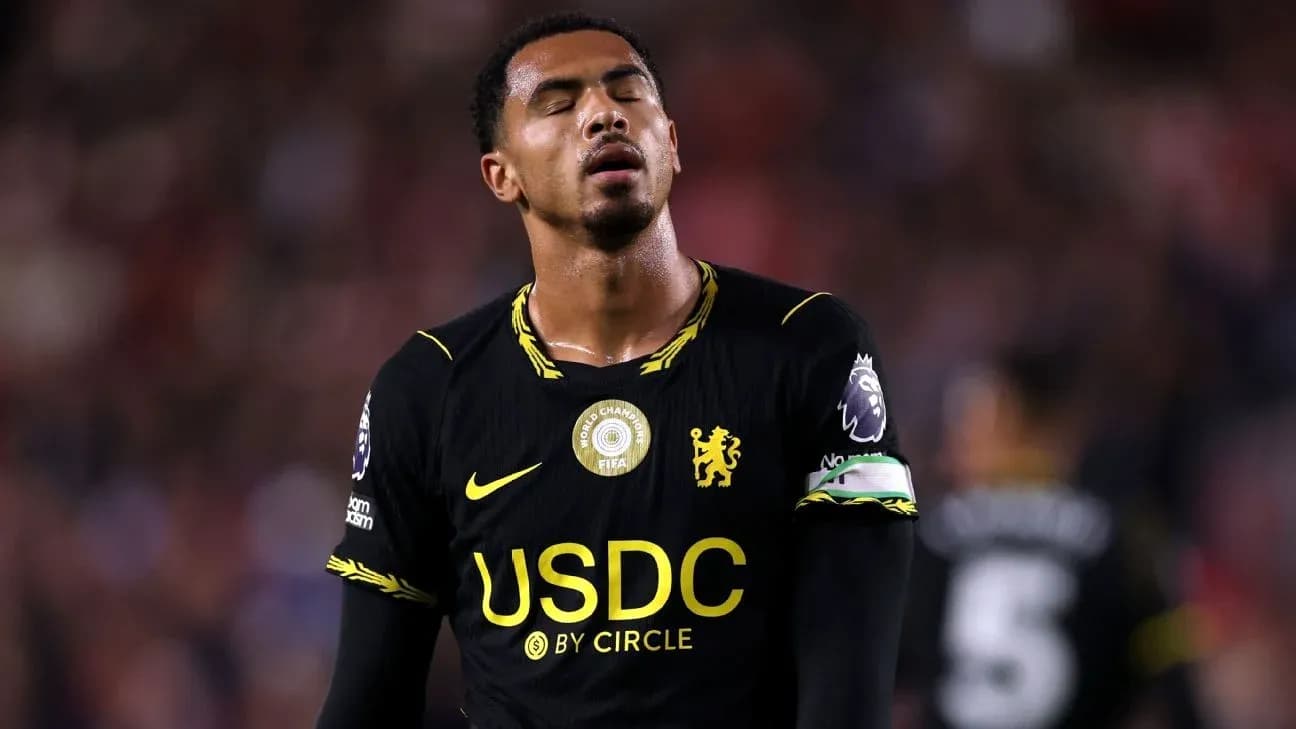 Player in black jersey looking dejected on field