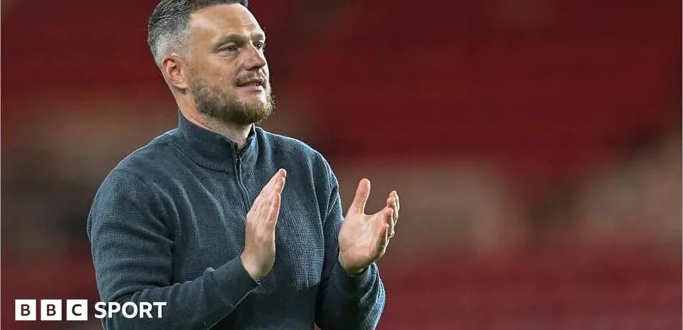 Manager applauding after match in stadium