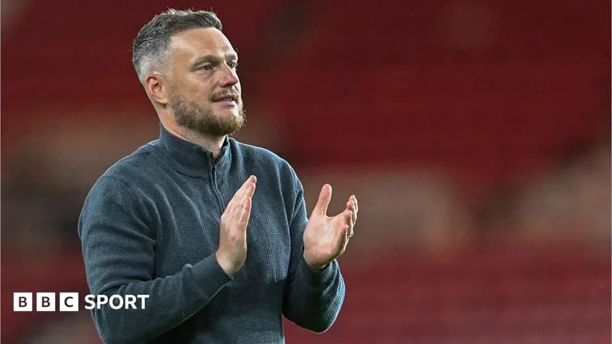 Manager applauding after match in stadium