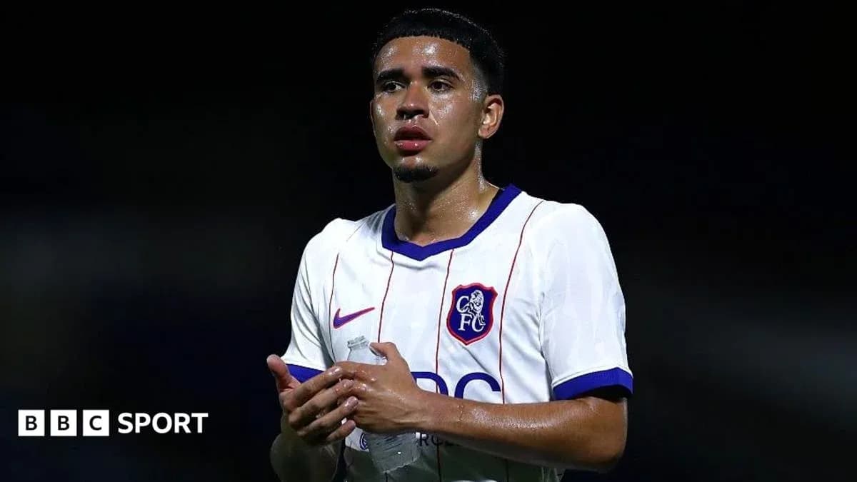 Player wearing Chelsea FC jersey holding water bottle