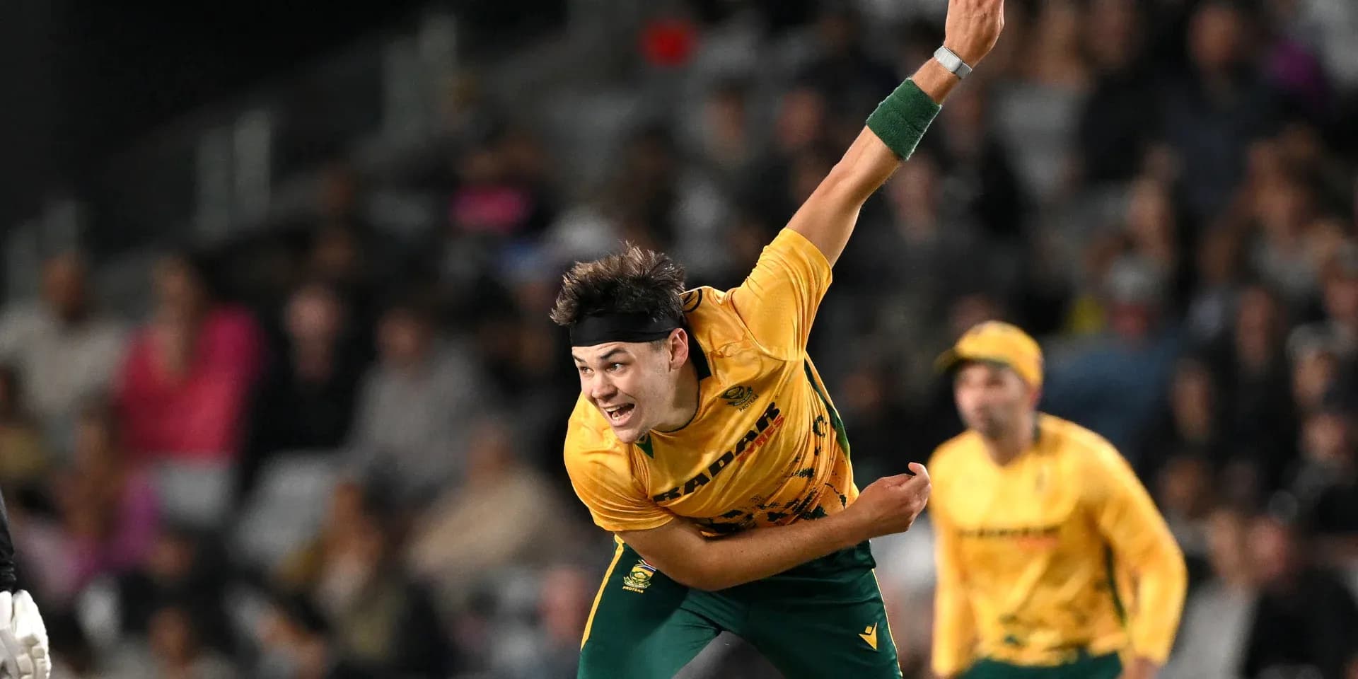 Bowler delivering a ball during cricket match