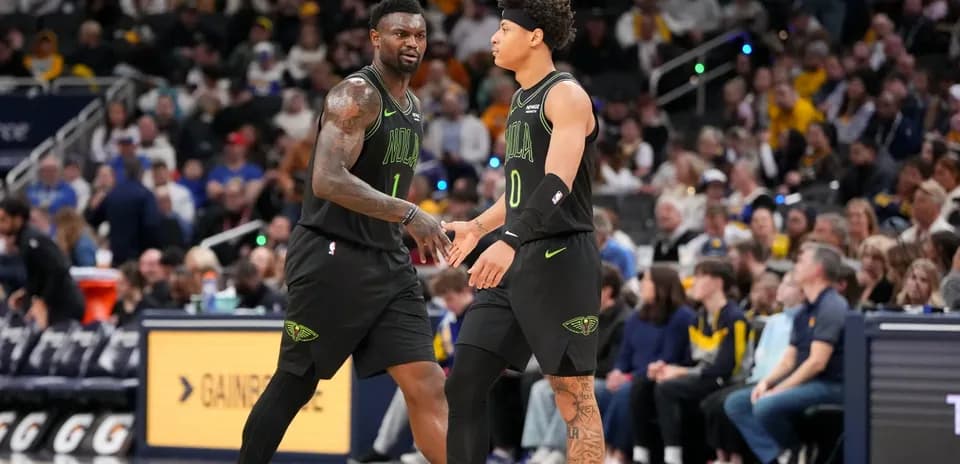 Two players from New Orleans Pelicans high-fiving during game