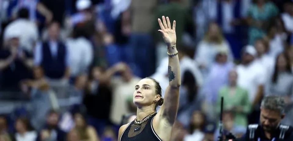 Player waving to crowd after match at venue