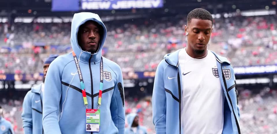 Two England players walking onto the field