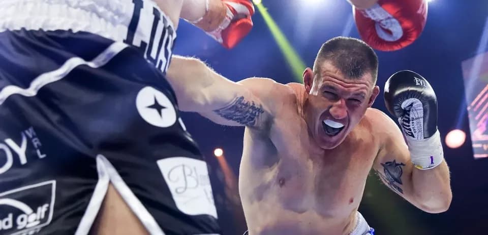 Boxer dodging a punch during intense match