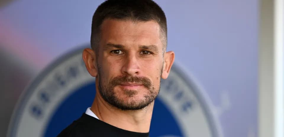 Man with short hair and beard posing for camera
