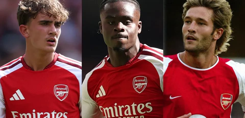 Three Arsenal players in red jerseys during match