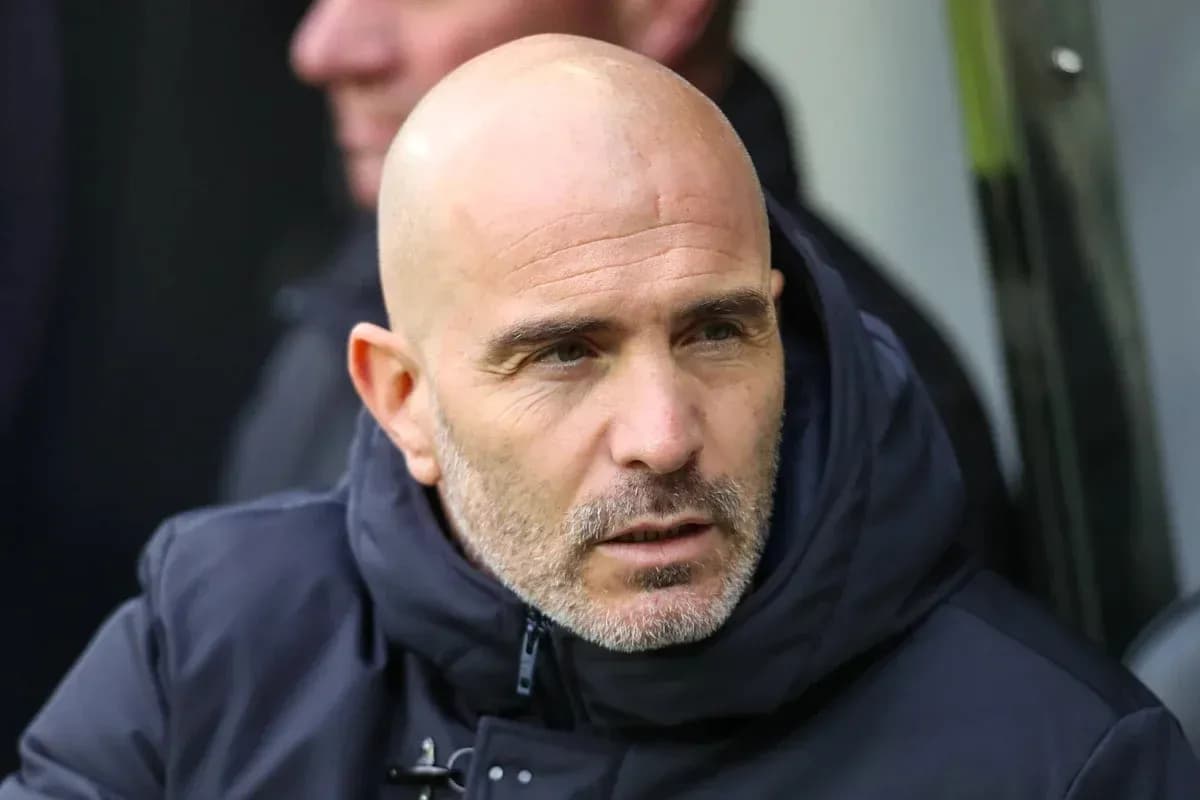 Coach in a dark jacket during a match