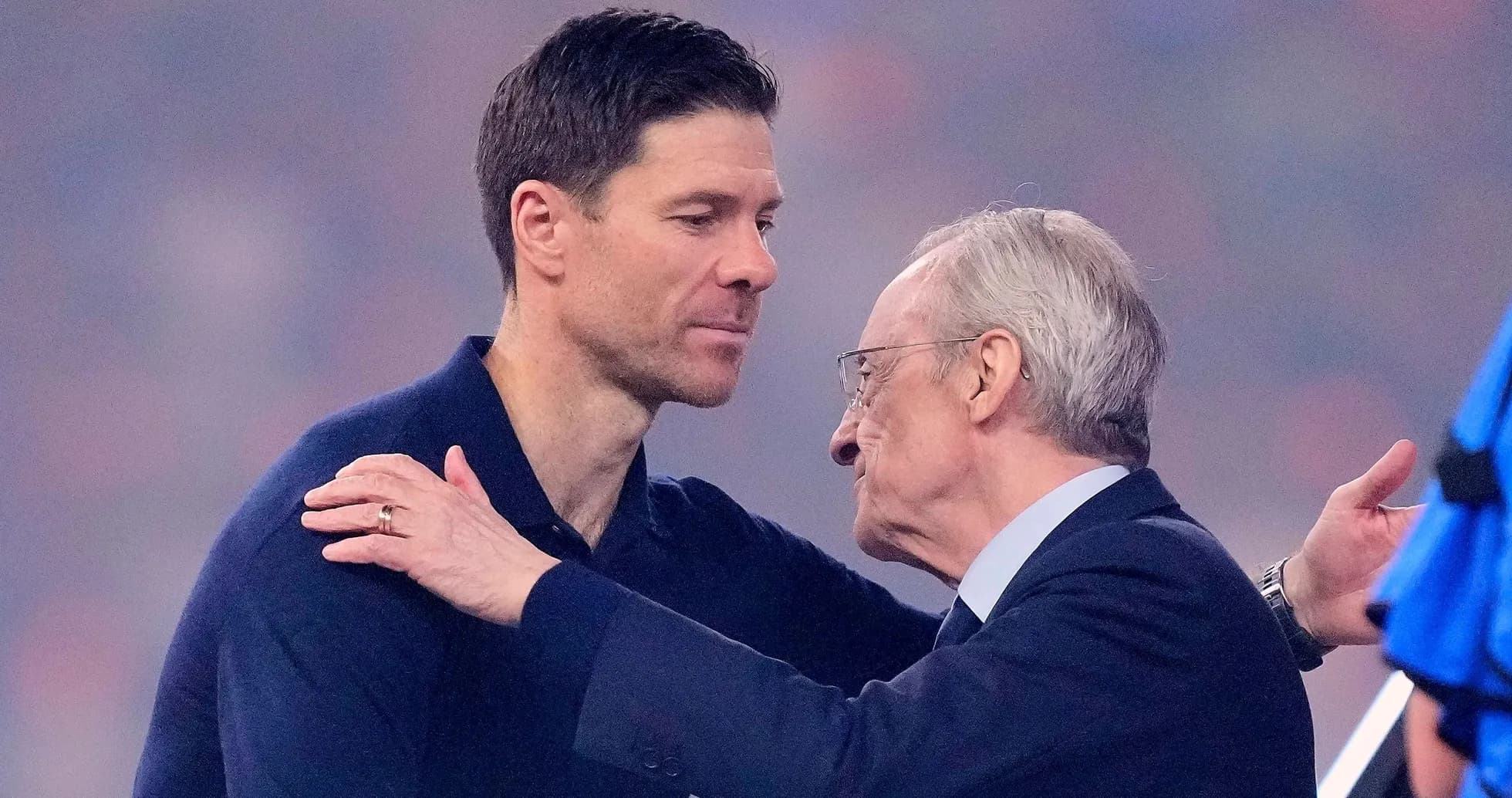 Two men embracing on a sports field