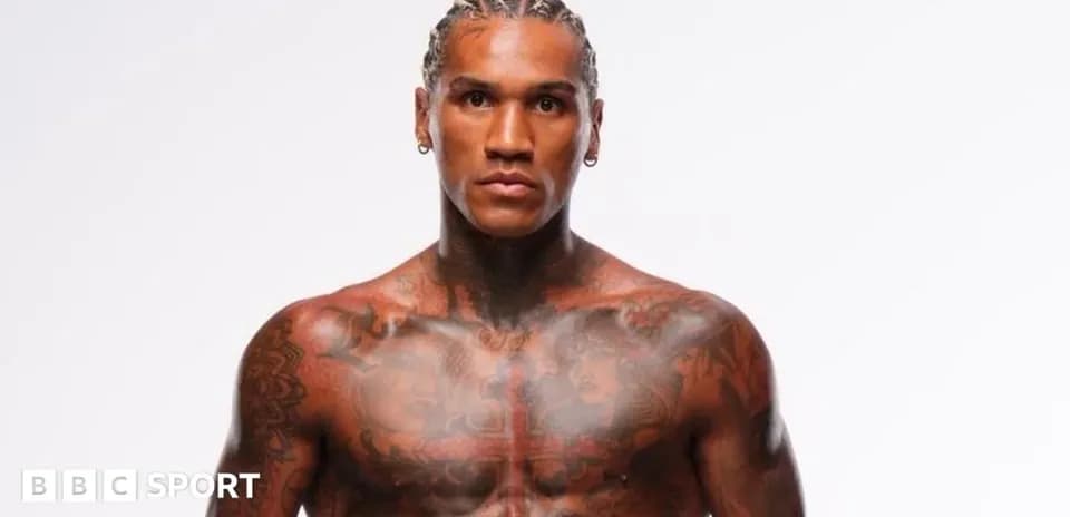 Muscular athlete posing with tattoos on chest