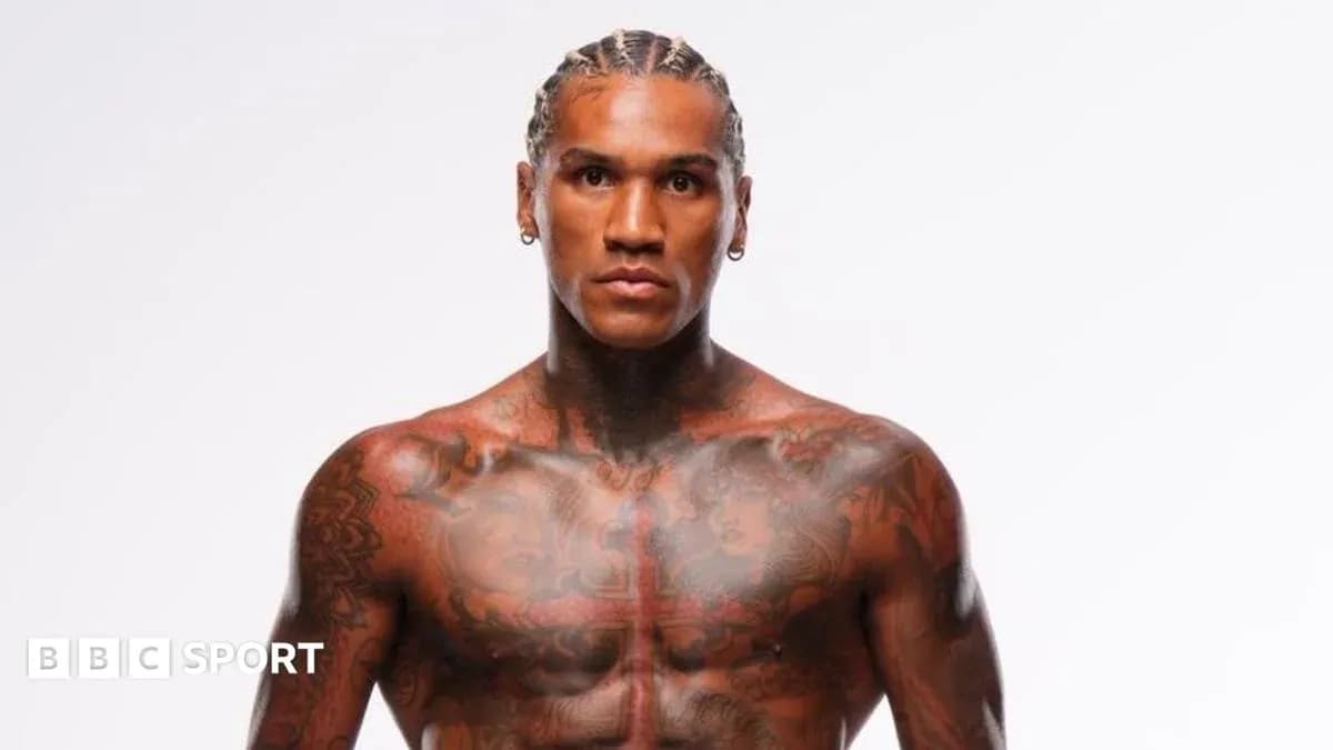 Muscular athlete posing with tattoos on chest