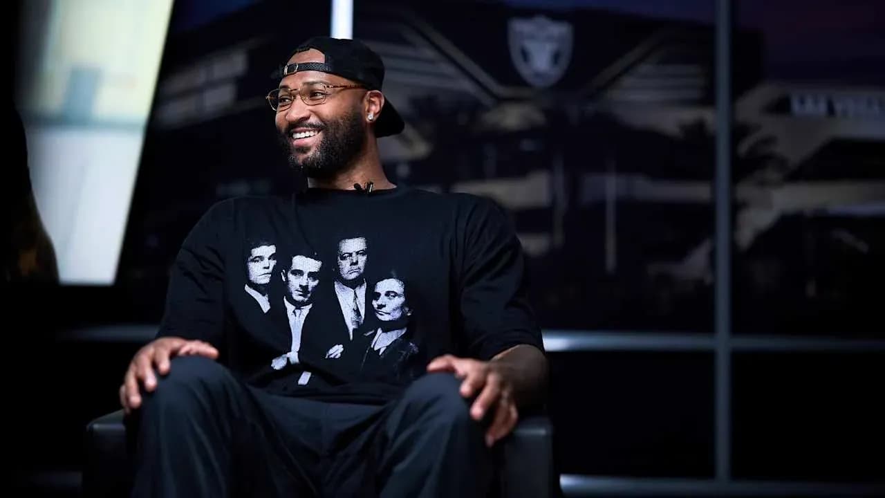 Athlete seated in interview setting, wearing graphic t-shirt