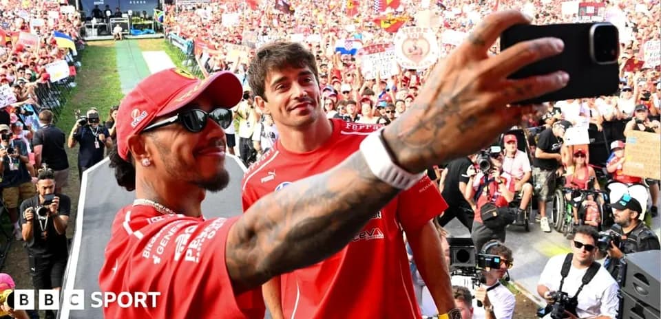 Drivers taking selfie with crowd in background