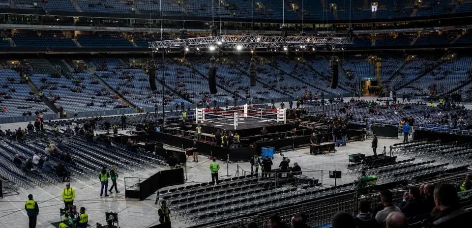 Boxing ring set up in large empty stadium
