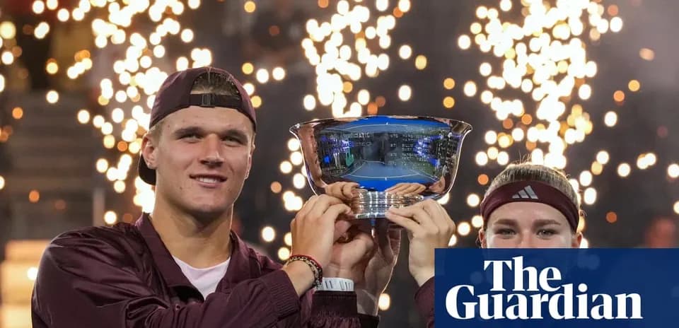 Players celebrating victory with trophy and fireworks
