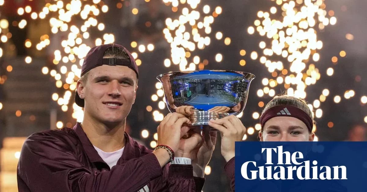 Players celebrating victory with trophy and fireworks