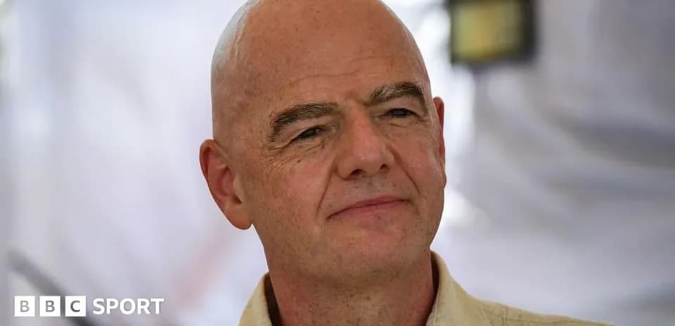 Man speaking at an event with a neutral background
