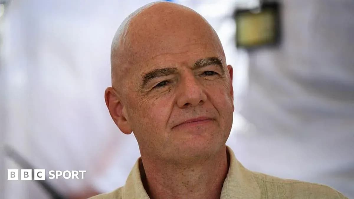 Man speaking at an event with a neutral background