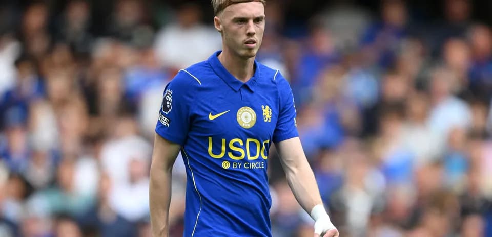 Player in blue Chelsea kit on the field