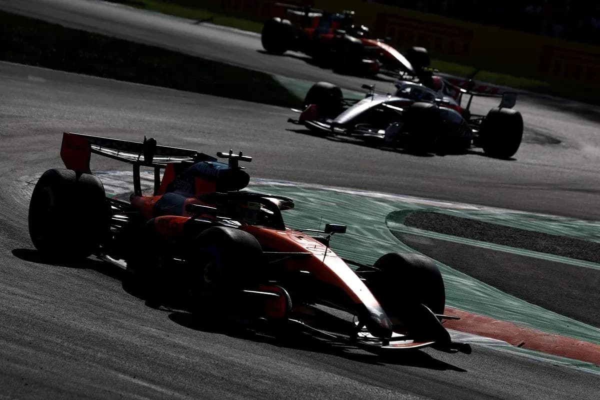 Formula 1 cars racing on a track corner