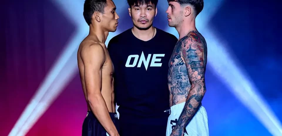Two fighters facing off with a referee in between