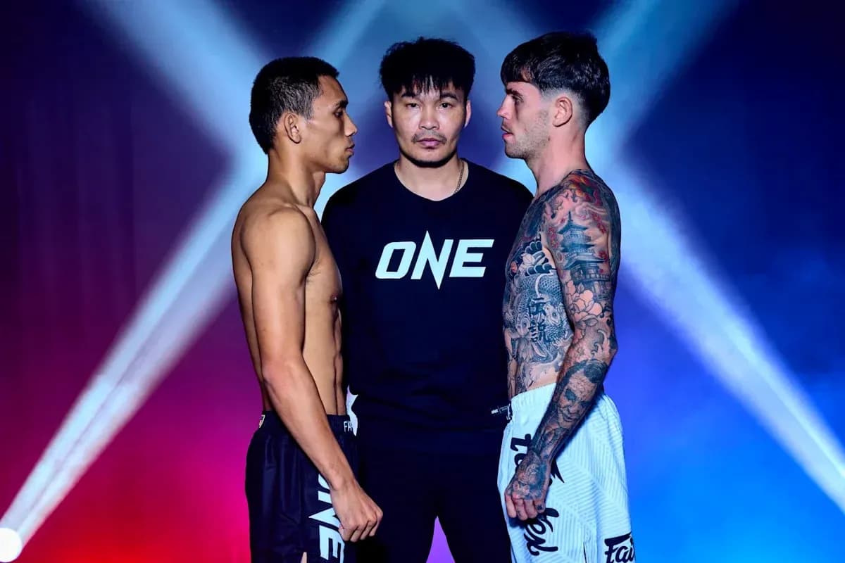 Two fighters facing off with a referee in between