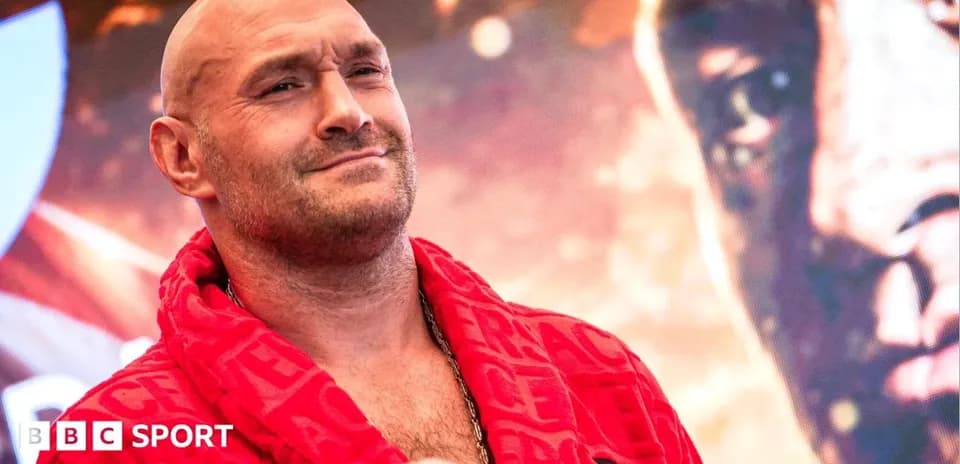 Boxer wearing red robe at promotional event