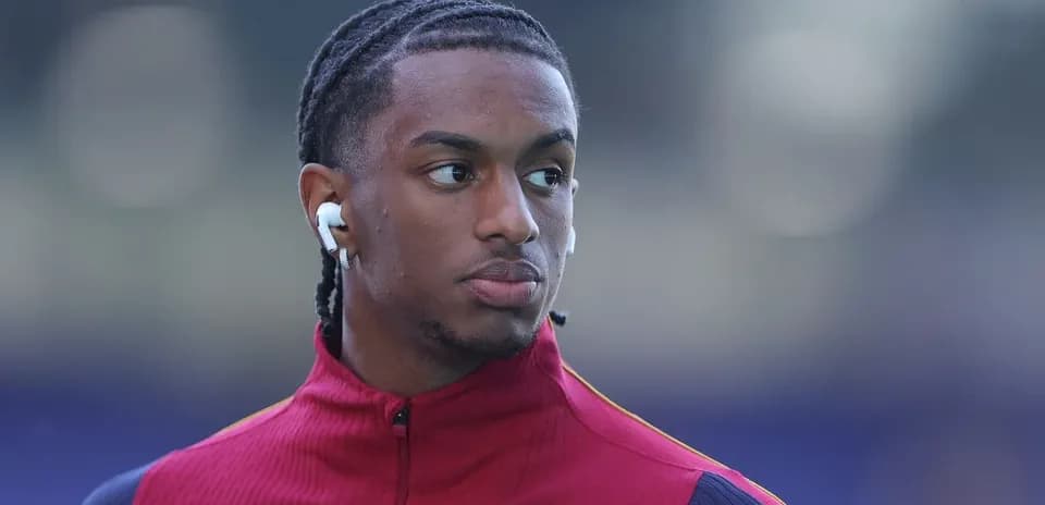 Player wearing earbuds during warm-up before match