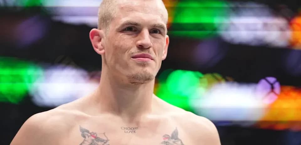 Fighter with tattoos standing in the ring