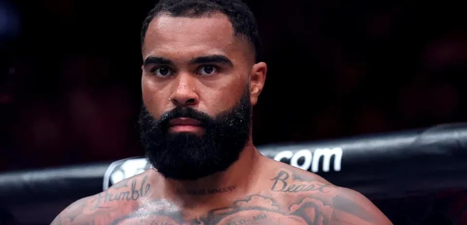 Fighter with tattoos and beard in the ring