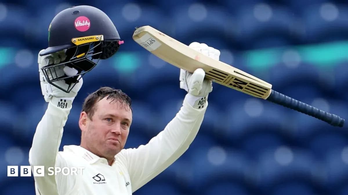 Cricketer celebrating with bat and helmet raised