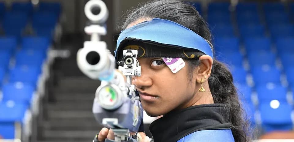 Shooter aiming with rifle at shooting range