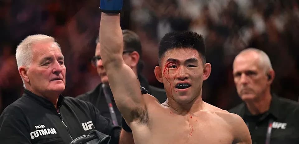 Fighter celebrating victory with a bloody face