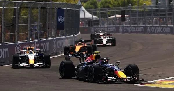 Formula 1 cars racing on a circuit track