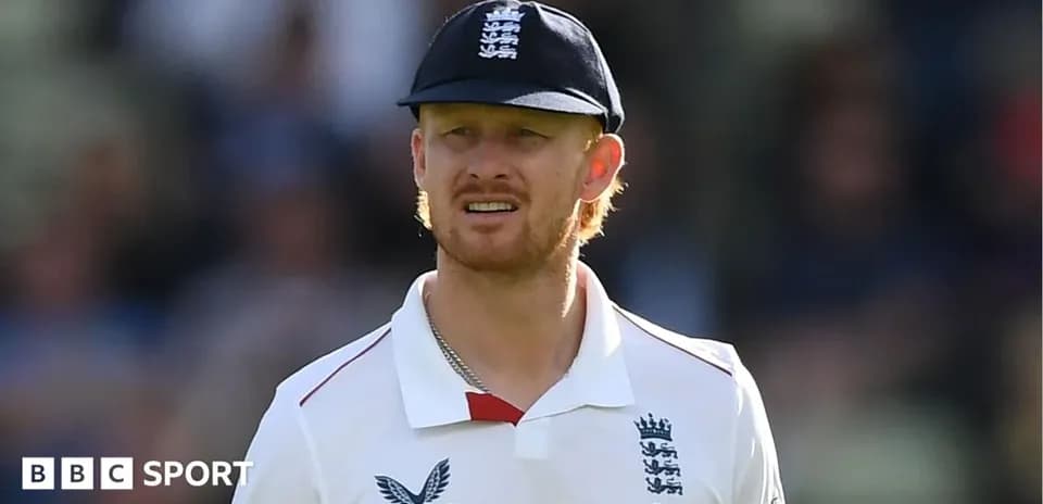 Cricketer wearing England kit and cap on field