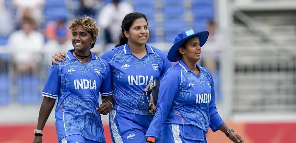 Three Indian women cricketers walking on field